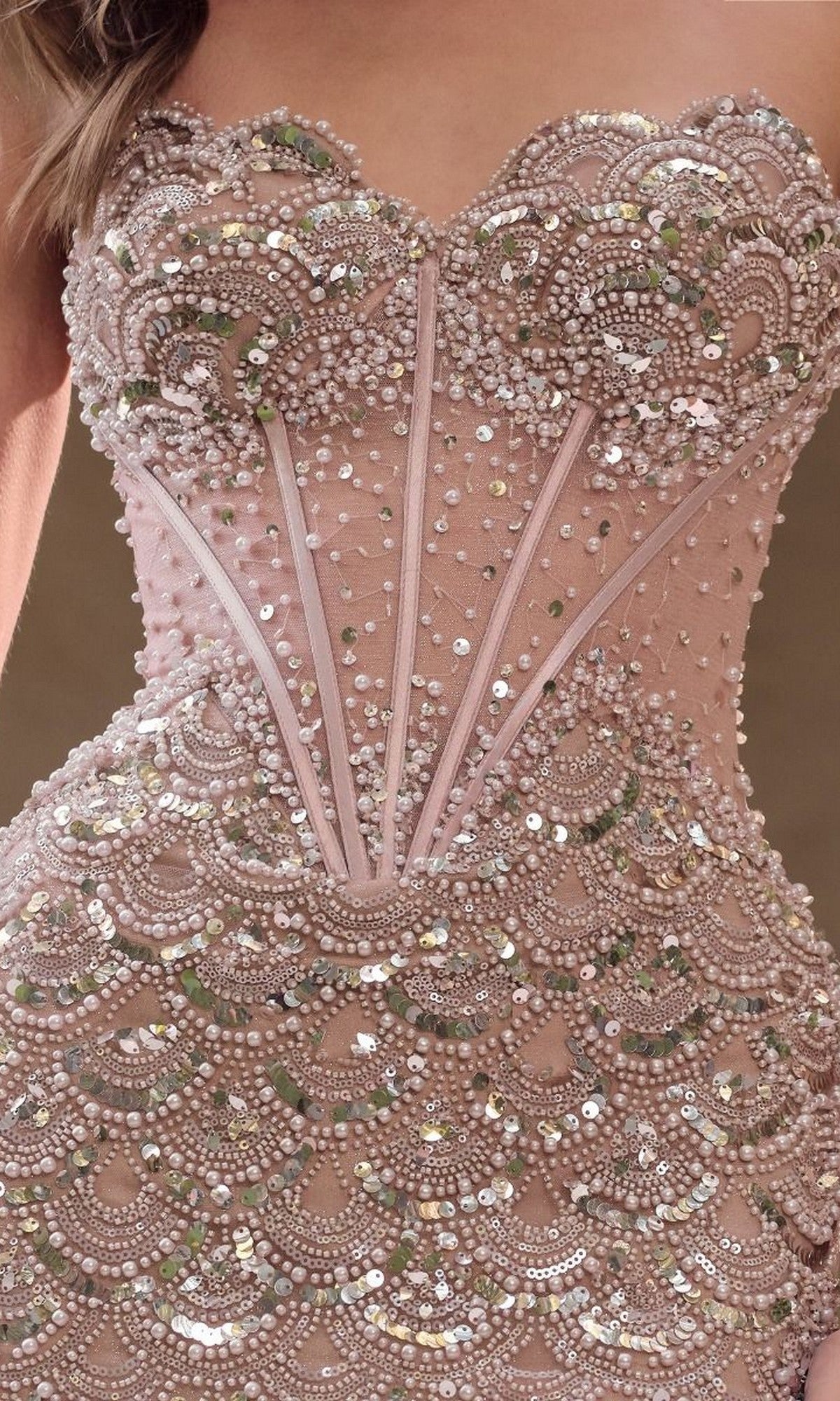 A close-up of the Andrea and Leo A1481 Nude Gold Beaded Prom Gown, featuring a strapless design with intricate sequins and scalloped embroidery.
